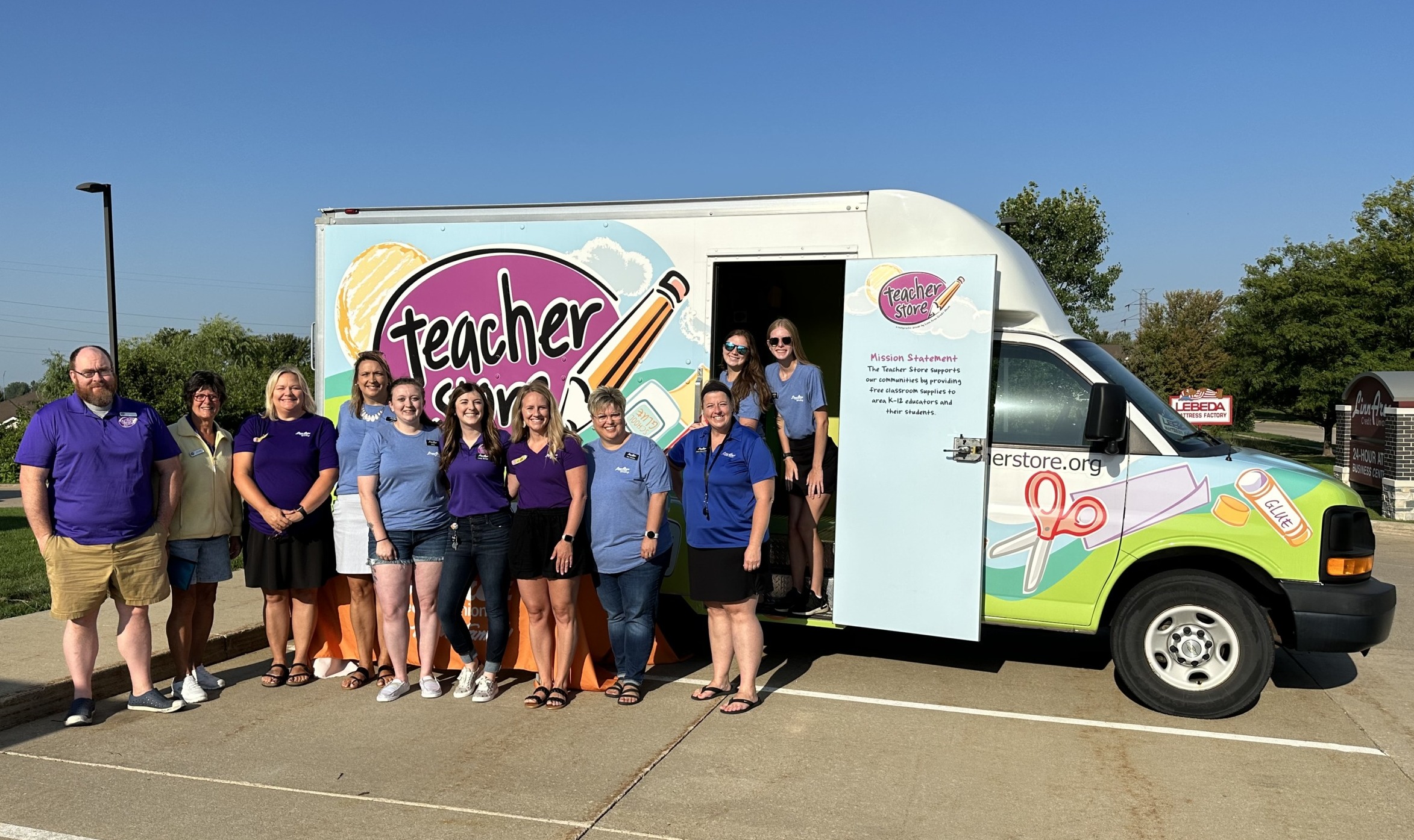 Teacher Store board of directors and volunteers standing in front of the Teacher Store truck.